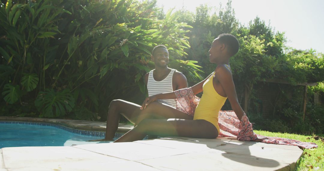 Couple enjoying sunny day at poolside in summertime - Free Images, Stock Photos and Pictures on Pikwizard.com