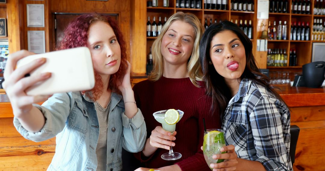 Diverse Friends Taking Group Selfie at Bar with Drinks