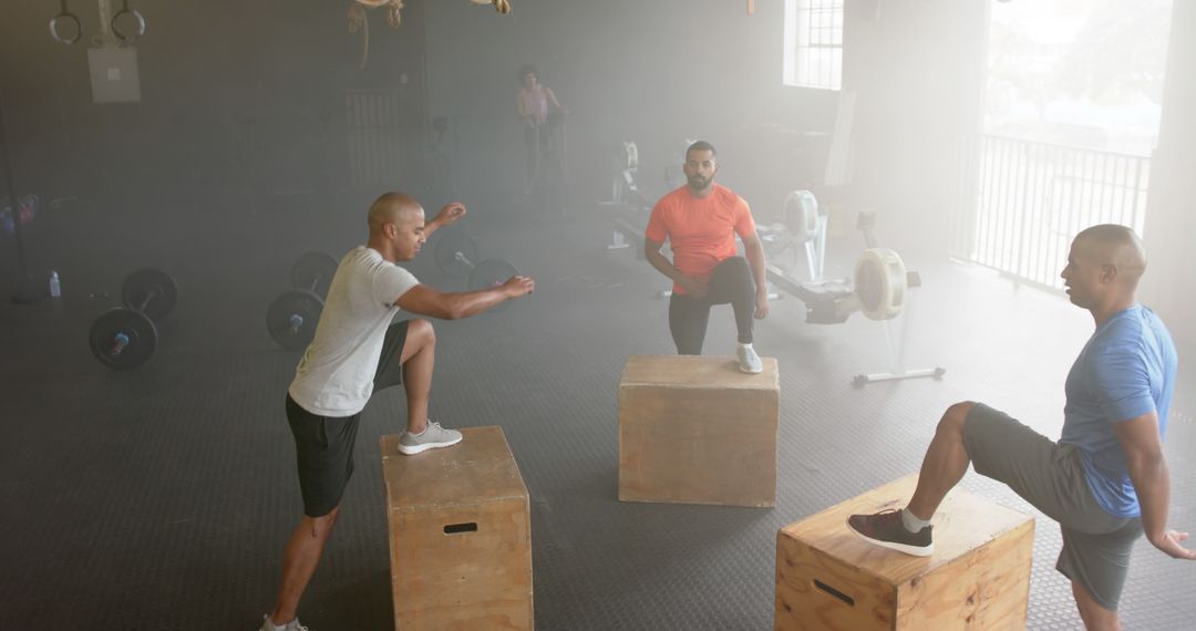 Group of Men Stretching on Boxes in Gym - Free Images, Stock Photos and Pictures on Pikwizard.com