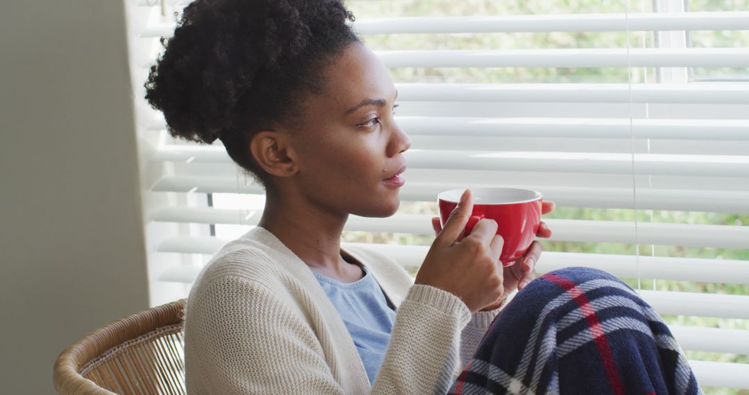 Woman Relaxing with Coffee by Window - Free Images, Stock Photos and Pictures on Pikwizard.com