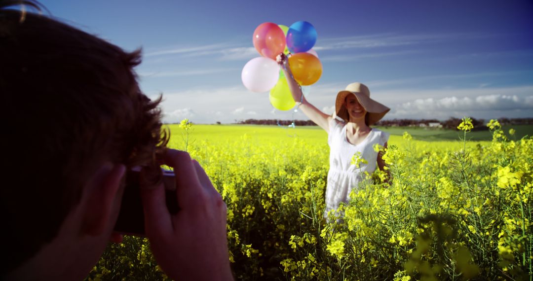 Woman with Balloons Posing in Yellow Flower Field - Free Images, Stock Photos and Pictures on Pikwizard.com