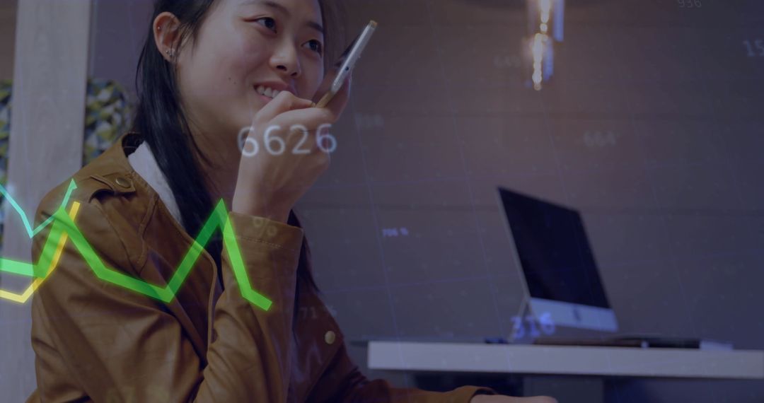 Businesswoman Analyzing Data While Using Smartphone in Modern Office