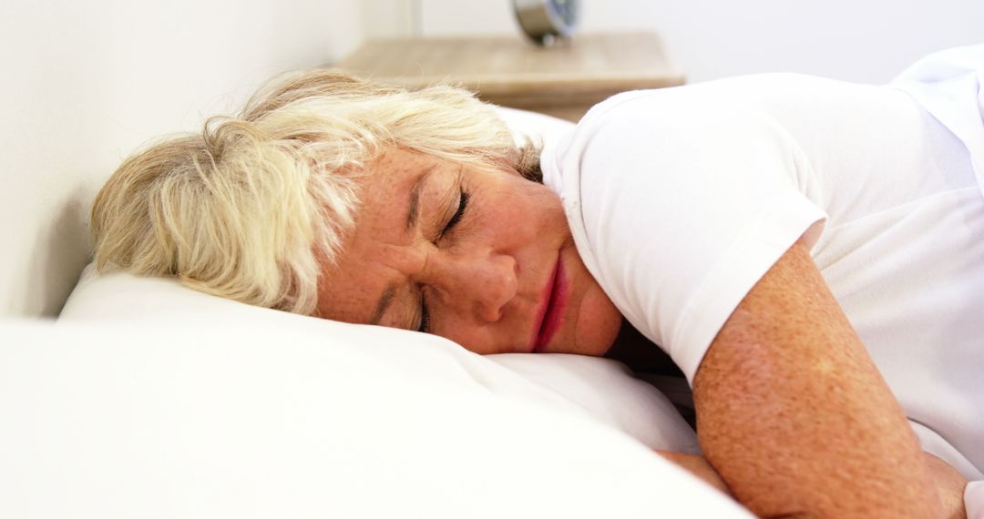 Senior Woman Sleeping Peacefully on Bed - Free Images, Stock Photos and Pictures on Pikwizard.com