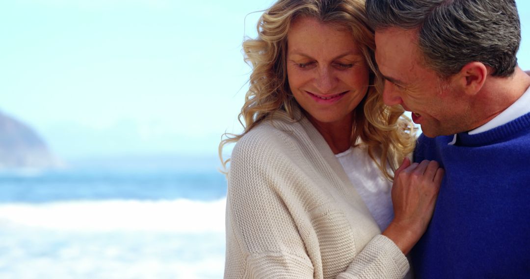 Happy Mature Couple Embracing on the Beach - Free Images, Stock Photos and Pictures on Pikwizard.com