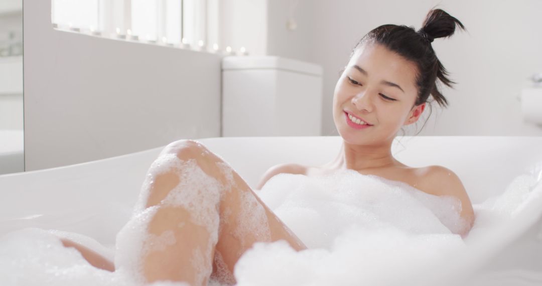 Smiling Woman Relaxing in Bathtub with Soap Bubbles - Free Images, Stock Photos and Pictures on Pikwizard.com