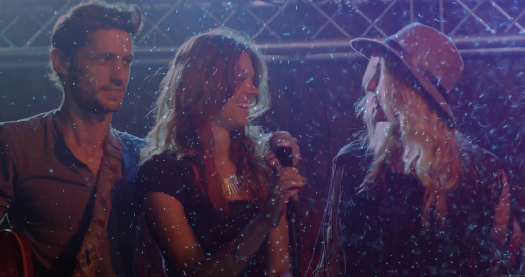 Energetic Band Performing with Snow and Lights on Stage