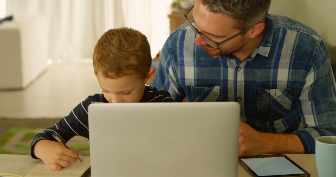 Father Helping Son with Homework at Laptop - Free Images, Stock Photos and Pictures on Pikwizard.com