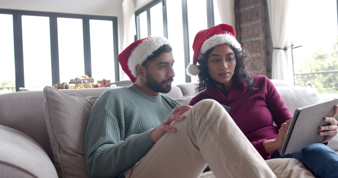 Couple Celebrating Christmas at Home with Tablet - Free Images, Stock Photos and Pictures on Pikwizard.com