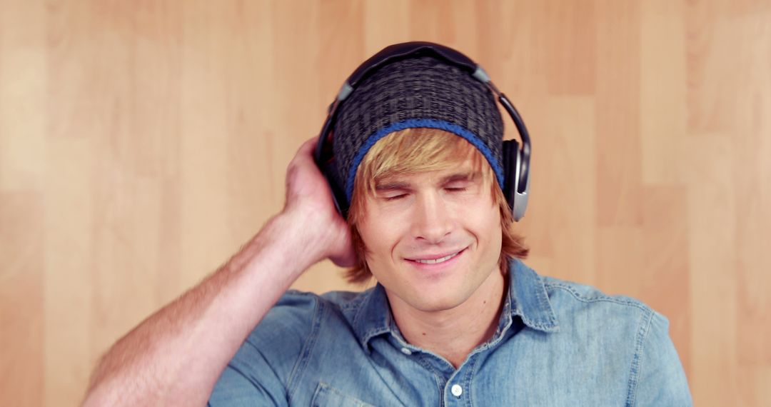 Young Man Listening to Music with Headphones and Smiling - Free Images, Stock Photos and Pictures on Pikwizard.com