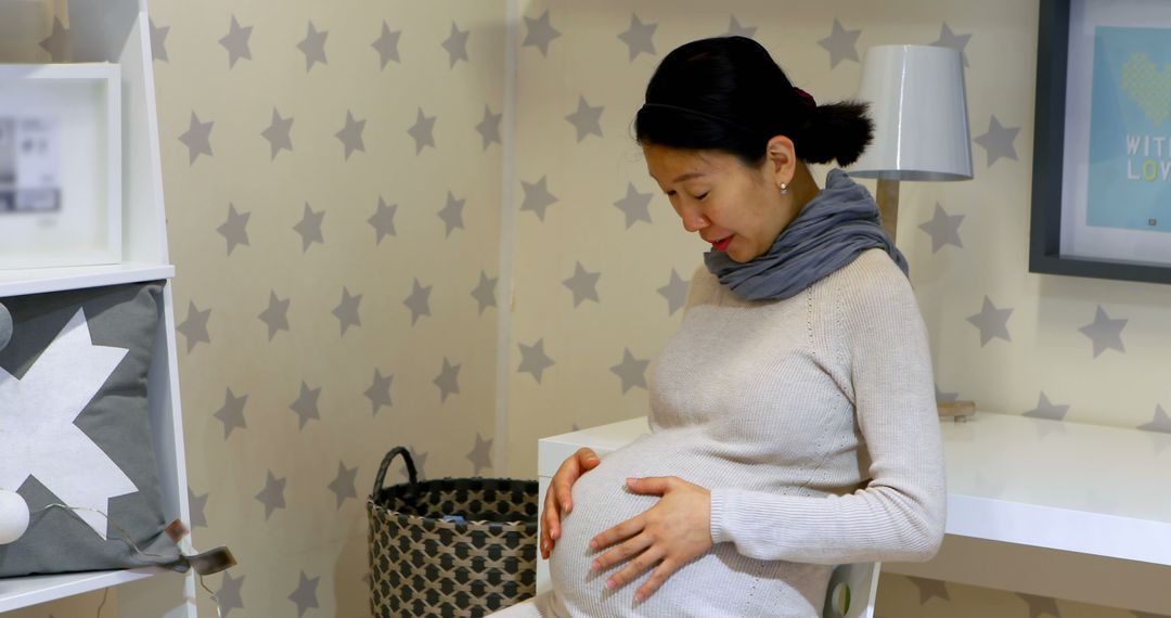 Pregnant Woman at Home Relaxing in Modern Nursery - Free Images, Stock Photos and Pictures on Pikwizard.com