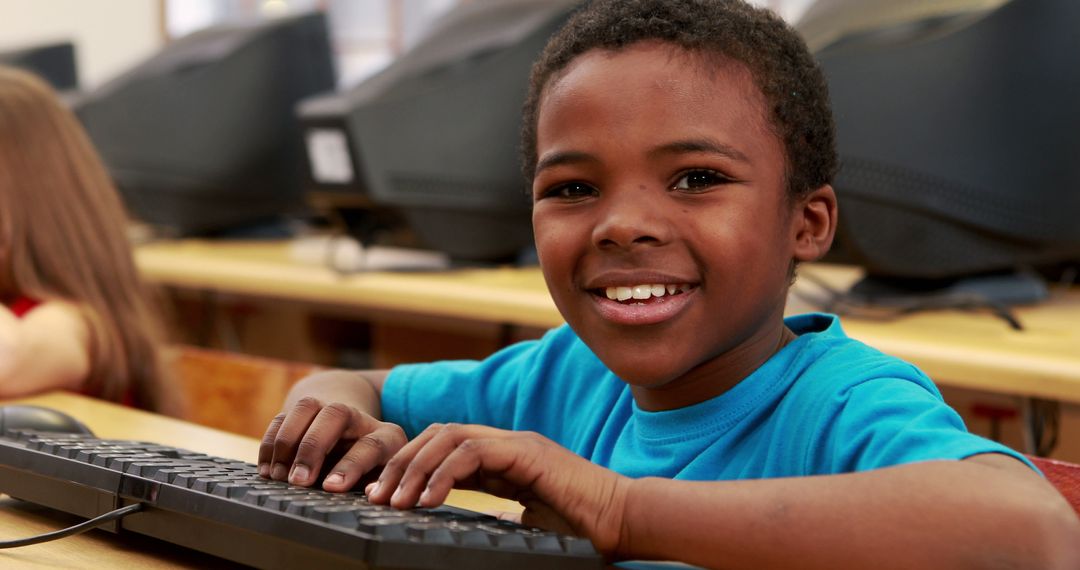 Smiling Child Learning Typing on Keyboard in Classroom - Free Images, Stock Photos and Pictures on Pikwizard.com