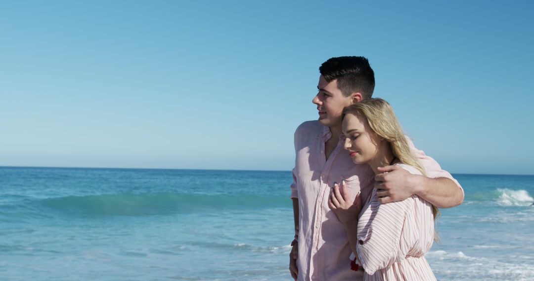 Young Couple Embracing on a Tranquil Sandy Beach - Free Images, Stock Photos and Pictures on Pikwizard.com