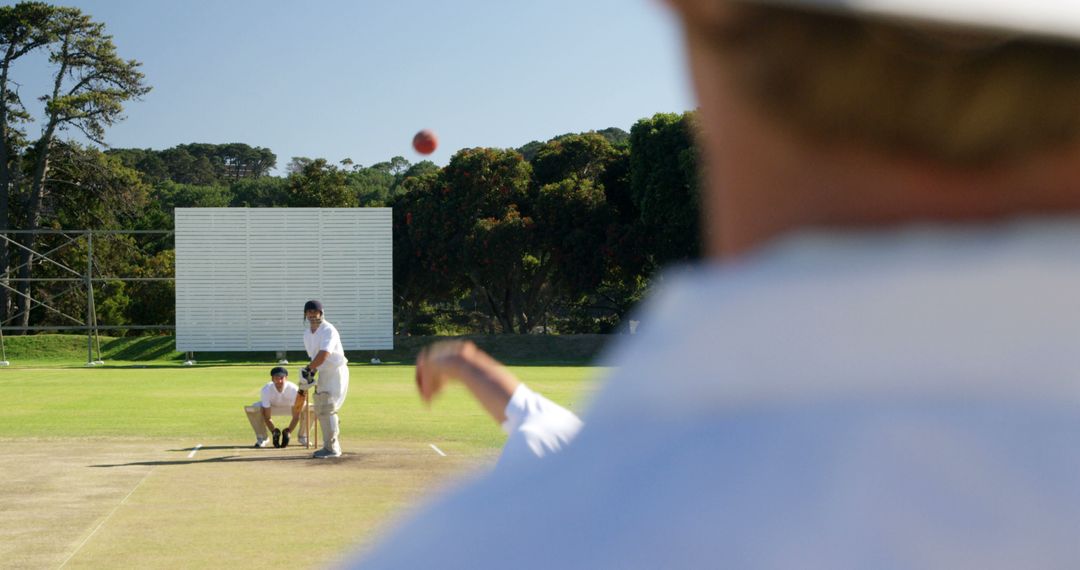 Bowler Delivering a Cricket Ball During Match on Sunny Day - Free Images, Stock Photos and Pictures on Pikwizard.com