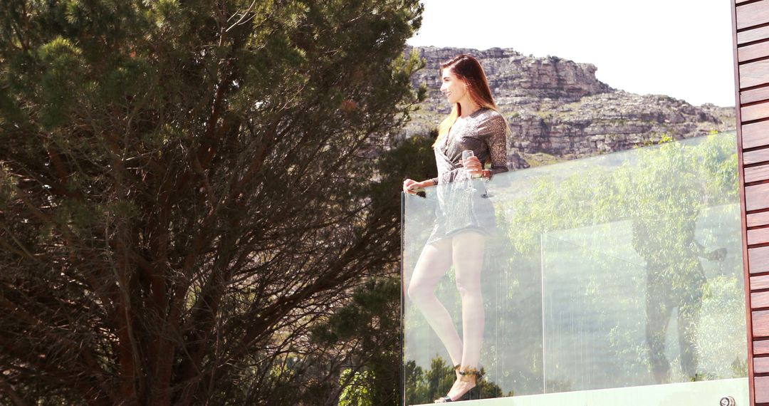 Woman Standing On Balcony Overlooking Mountain Landscape - Free Images, Stock Photos and Pictures on Pikwizard.com