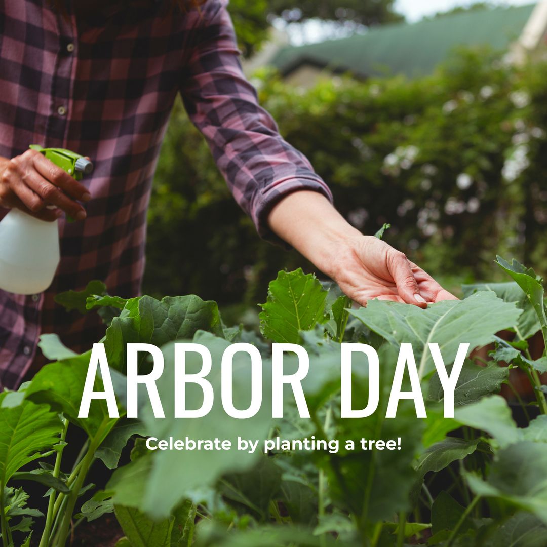 Celebrating Arbor Day by Watering Lush Plants in a Garden