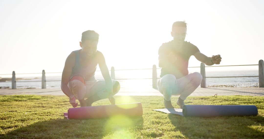 Two Men Practicing Yoga on Grass at Seaside During Sunrise - Free Images, Stock Photos and Pictures on Pikwizard.com