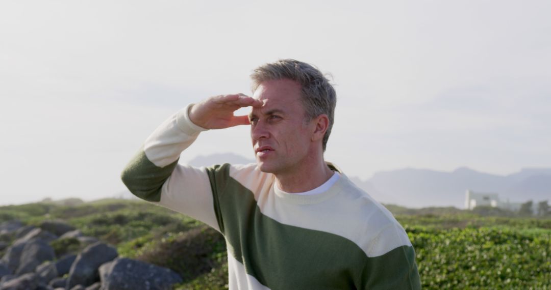 Man Looking Into Distance with Hand Over Eyes Outdoors - Free Images, Stock Photos and Pictures on Pikwizard.com