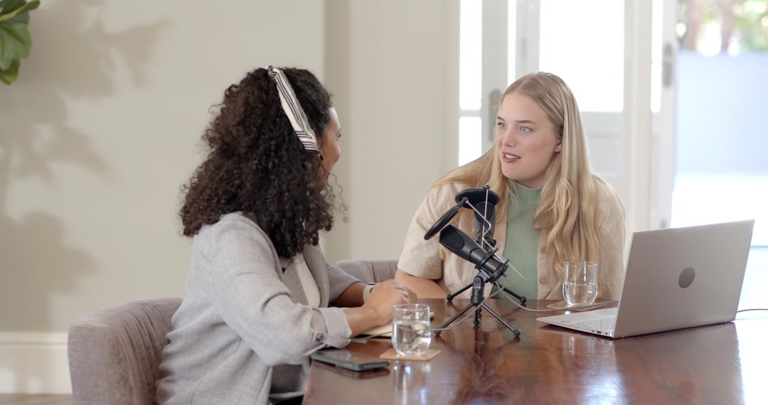 Diverse Female Podcasters Collaborating in Modern Studio
