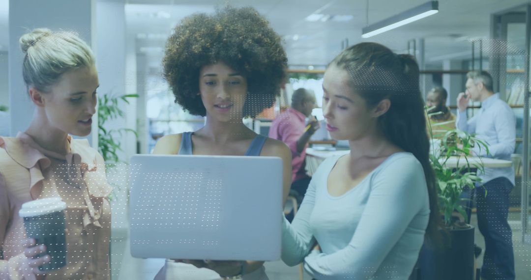 Diverse Women Collaborating in Modern Office with Technology