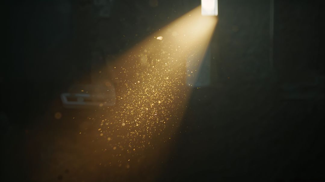 Sunlight Beam Streaming Through High Window Illuminating Dust Motes in Dark Garage Interior