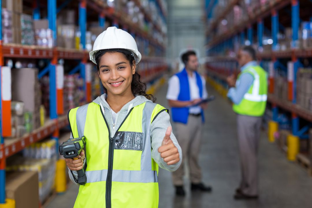 Female warehouse worker showing thumbs up sign - Free Images, Stock Photos and Pictures on Pikwizard.com