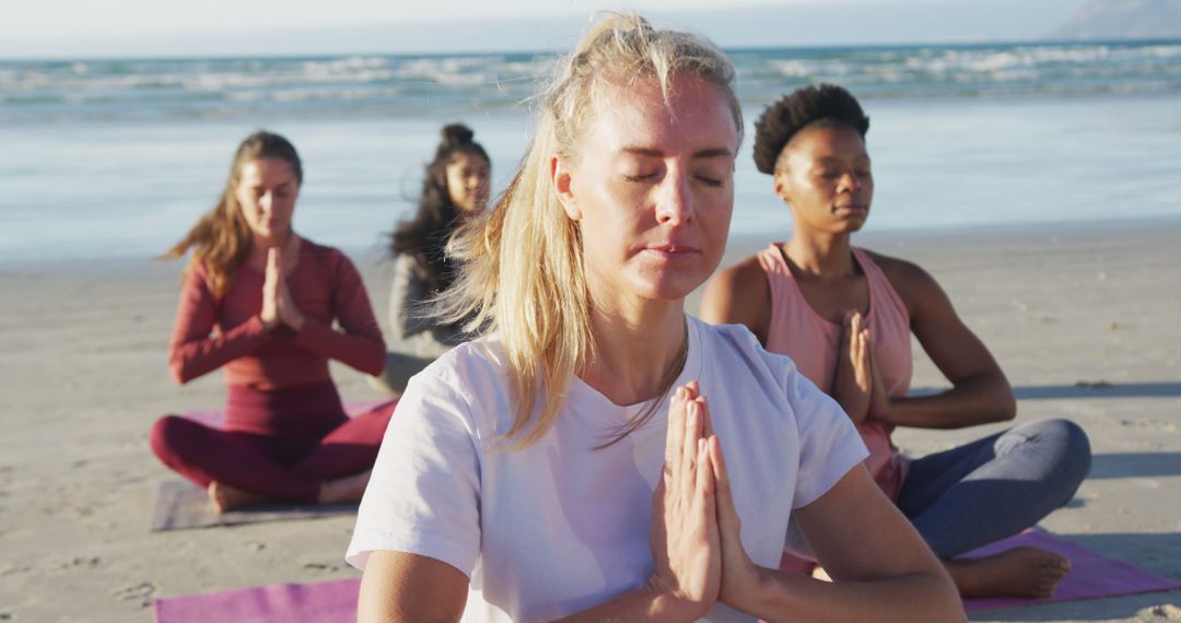 Group of diverse female friends meditating at the beach - Free Images, Stock Photos and Pictures on Pikwizard.com
