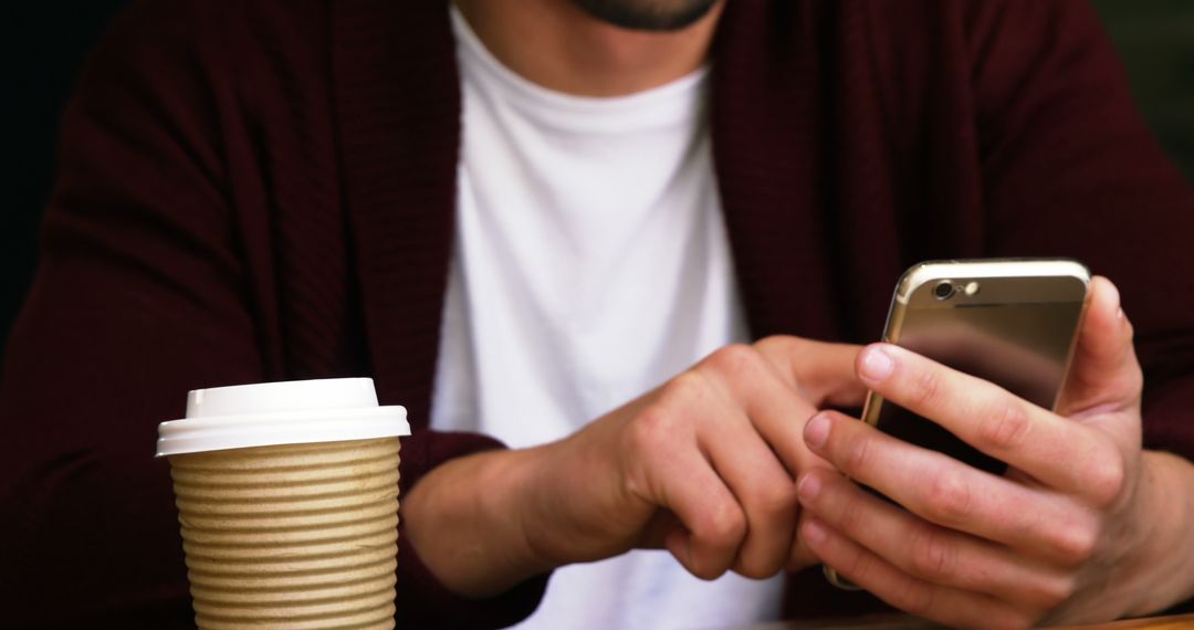 Man Using Smartphone With Takeaway Coffee Cup - Free Images, Stock Photos and Pictures on Pikwizard.com