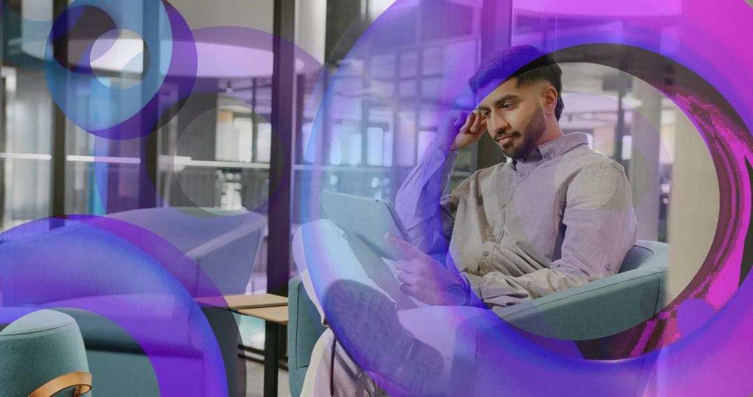 Man Engagedly Reading Tablet In Modern Office With Abstract Purple Overlay