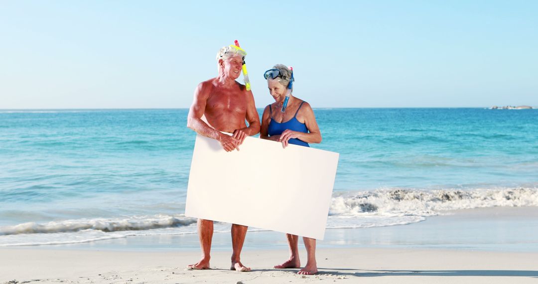 Senior Couple Snorkeling at Tropical Beach Holding Blank Sign - Free Images, Stock Photos and Pictures on Pikwizard.com