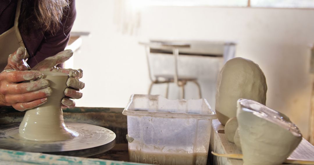 Potter Shaping Clay on Pottery Wheel in Ceramic Studio - Free Images, Stock Photos and Pictures on Pikwizard.com