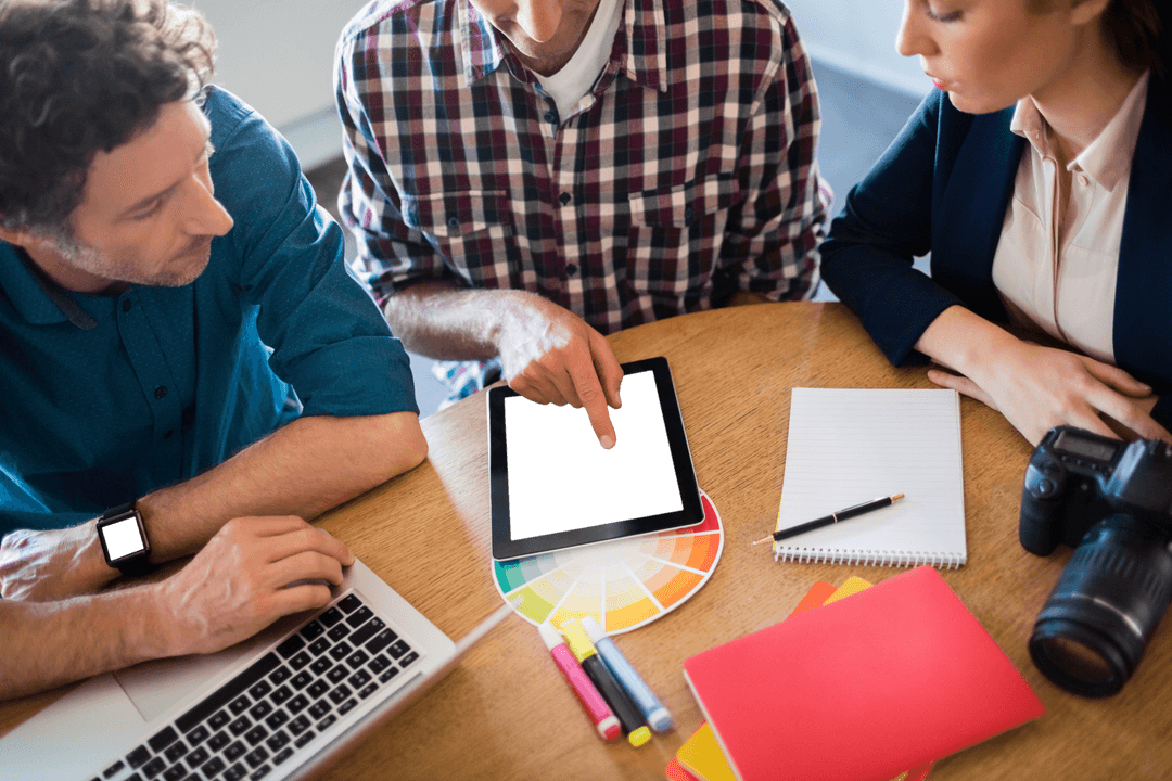 Collaborative Design Meeting with Technology and Color Palette on Desk