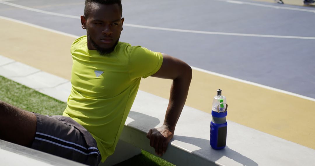 Young Athlete Resting on Bench After Outdoor Training Session - Free Images, Stock Photos and Pictures on Pikwizard.com