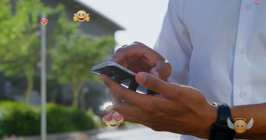 Man Using Smartphone with Emoticons Depicting Digital Interaction