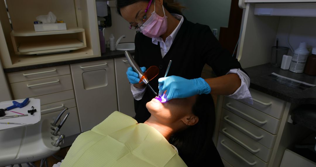 Dentist Performing Oral Examination on Patient in Clinic - Free Images, Stock Photos and Pictures on Pikwizard.com