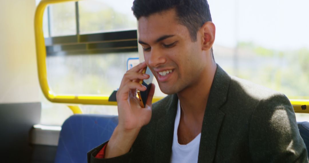 Smiling Man Talking on Phone During Commute on Bus - Free Images, Stock Photos and Pictures on Pikwizard.com