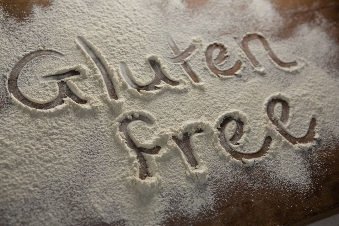 The word gluten free written on sprinkled flour - Free Images, Stock Photos and Pictures on Pikwizard.com
