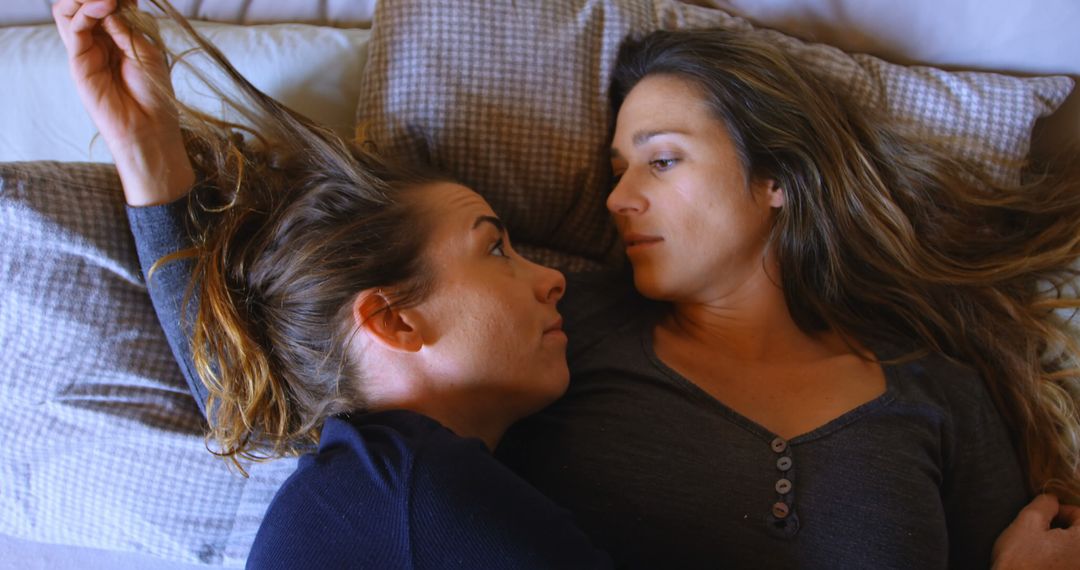 Two Women Lying in Bed Sharing an Intimate Moment - Free Images, Stock Photos and Pictures on Pikwizard.com