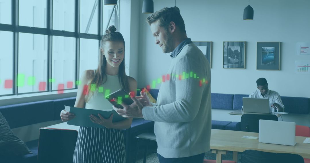 Colleagues Analyzing Financial Data on Digital Devices