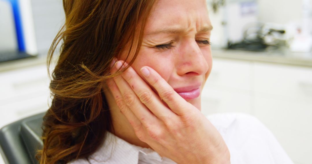 Woman Experiencing Severe Tooth Pain in Dental Clinic - Free Images, Stock Photos and Pictures on Pikwizard.com