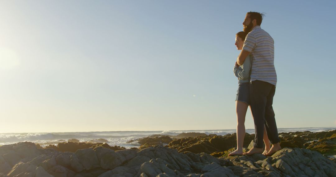 Romantic young couple embracing on rock at beach - Free Images, Stock Photos and Pictures on Pikwizard.com