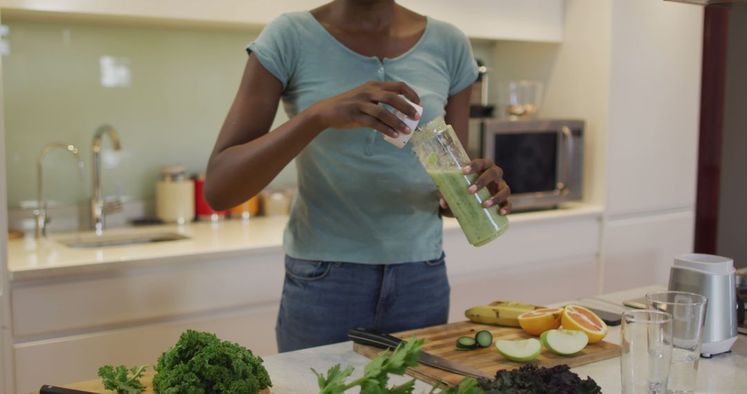 Healthy Lifestyle Young Woman Making Green Smoothie Kitchen - Free Images, Stock Photos and Pictures on Pikwizard.com