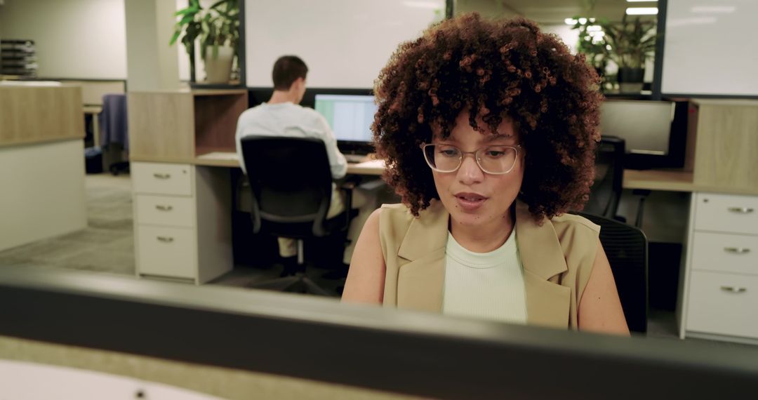 Focused Team Working in Modern Open Plan Office