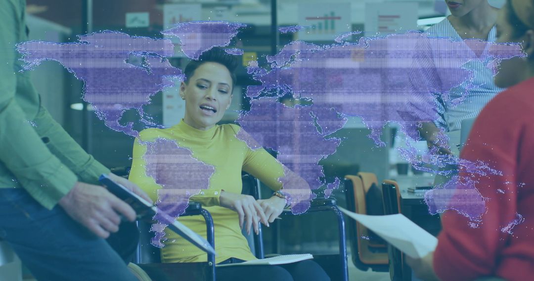Leader in Wheelchair Engaging with Team Over Digital World Map