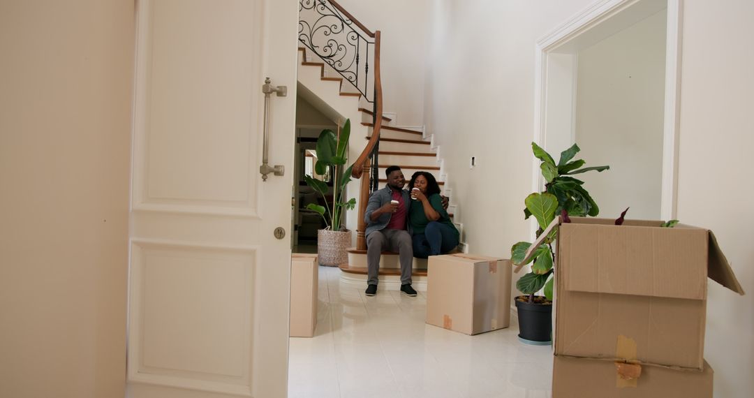 Couple Enjoying New Home Move-In Together with Cardboard Boxes