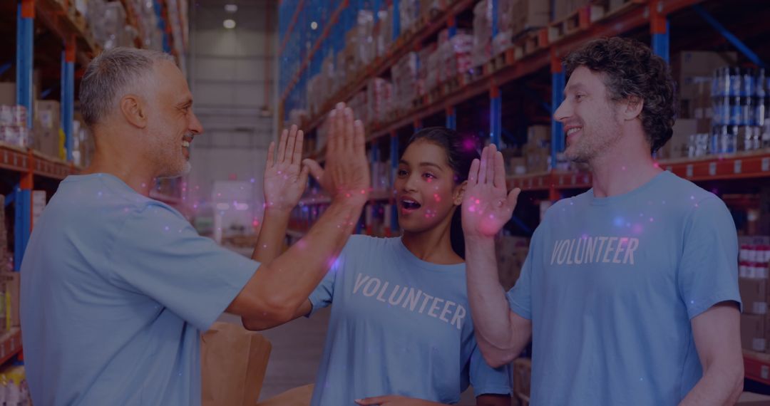 Diverse Volunteers High-Fiving in Warehouse