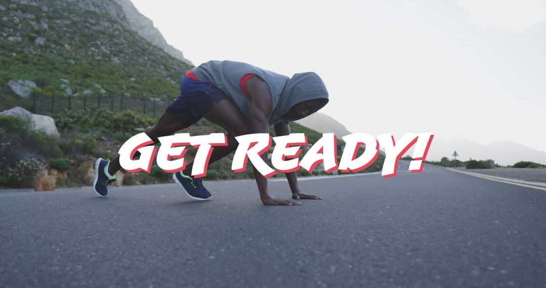 Athlete in Start Position on Scenic Mountain Road Inspires Motivation