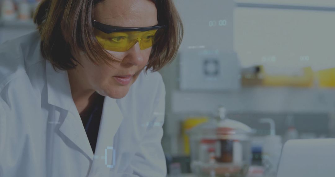 Female Scientist Analyzing Data with Laptop in Laboratory