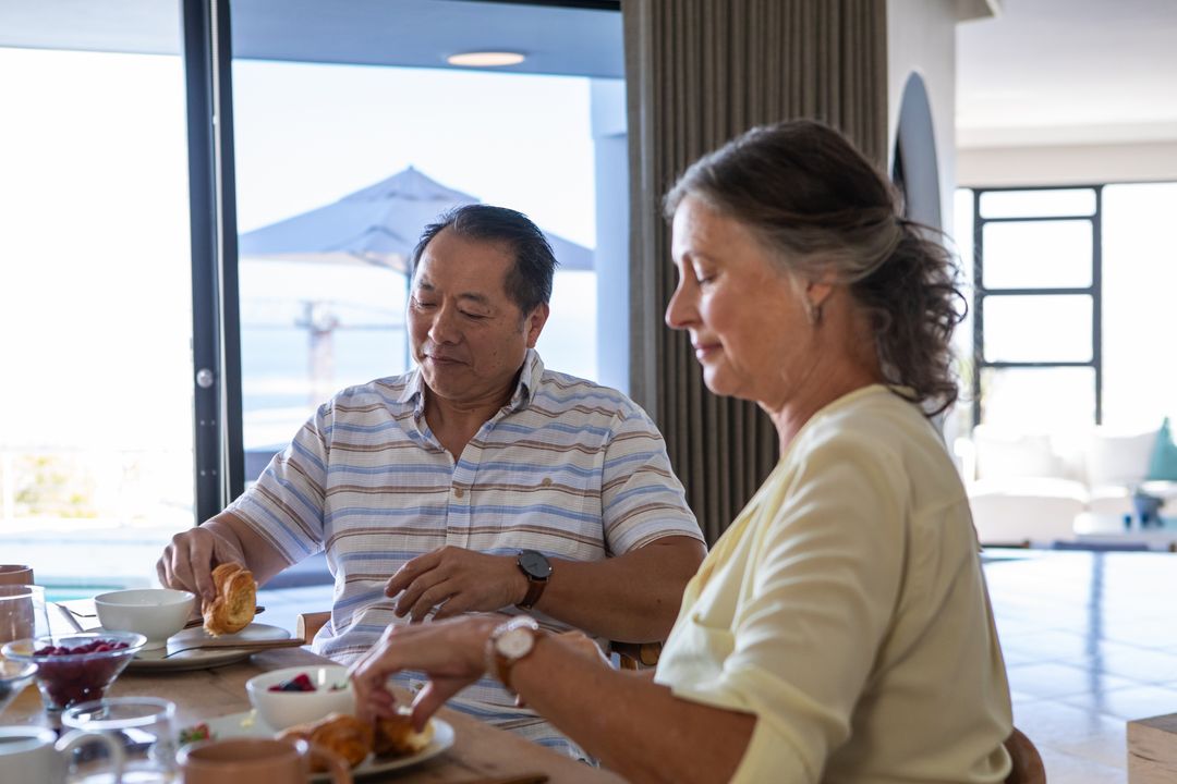 Senior Couple Enjoying Elegant Breakfast with Ocean View