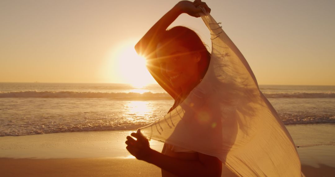 Joyful Woman Enjoying Tranquil Beach Sunset - Free Images, Stock Photos and Pictures on Pikwizard.com