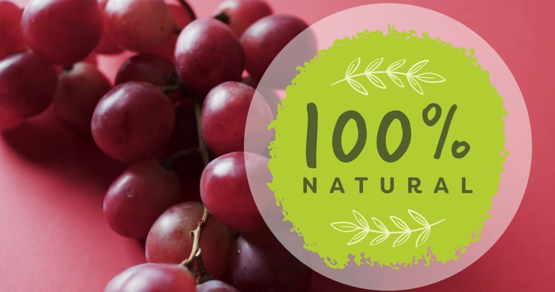 Colorful 100 Percent Natural Grapes Display on Pink Background